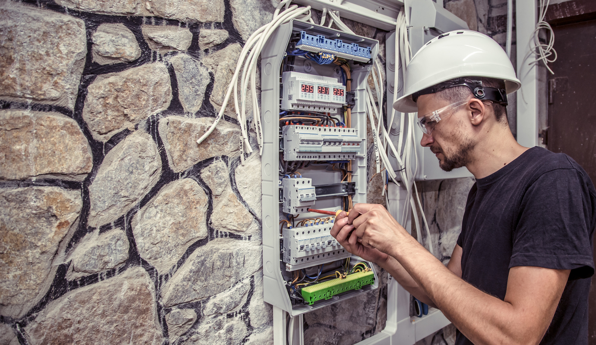 Technician Servicing Electrical Control Panel